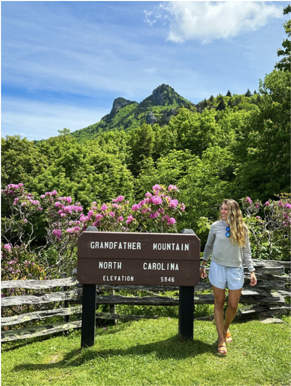 girl standing next to the Grandfather Mountain sign in North Carolina