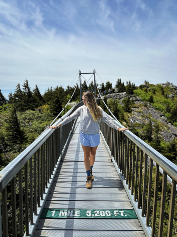 girl walking the Mile High Swinging Bridge in Boone, North Carolina