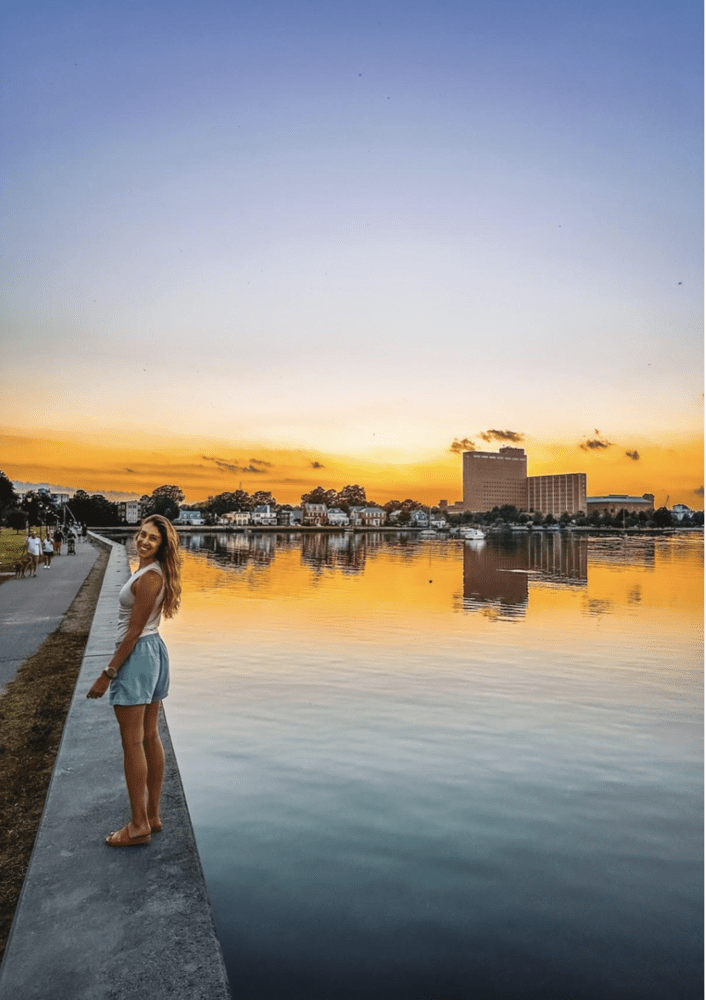 a girl walks along the riverfront in Portsmouth Virginia
